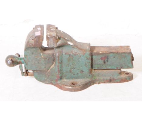 A vintage 20th century cast metal woodworking industrial swivel vice. Having table hole fittings, with swivel arm in worn pai