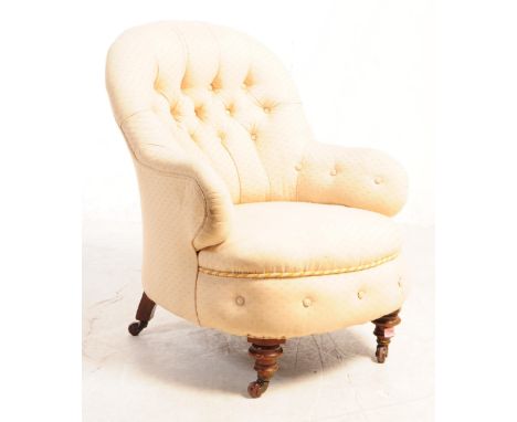 A 19th century Victorian nursing chair. The chair having tufted button spoon back and being upholstered in a stitched cream f