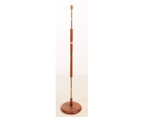 A mid Century retro brass and teak floor standing standard lamp. Having circular wood base and central brass column with furt