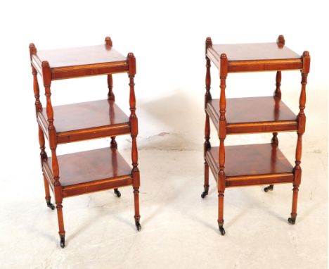 A pair of 20th century Victorian Revival lamp stands / side tables. Each table raised on castors, having a three tier design 