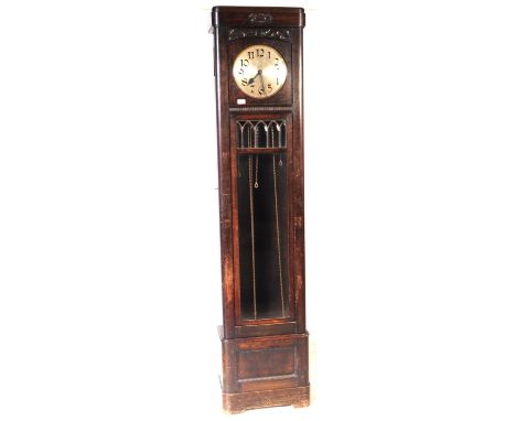 An early 20th century circa 1930s Art Deco oak wood longcase grandfather clock. The clock raised on a plinth base, with recta