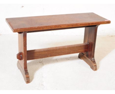 An early 20th century country oak wood bench / stool. The stool having a rectangular top, raised on squared supports united b