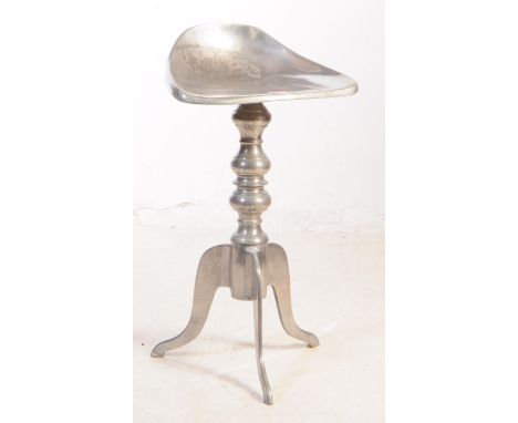 A vintage 20th century Italian chrome metal stool having saddle type seat over pedestal tripod base with stylised turned effe