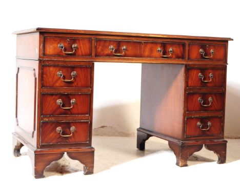 A 19th century revival mahogany pedestal desk. The desk raised on twin pedestals, each having bracket feet, below a bank of t
