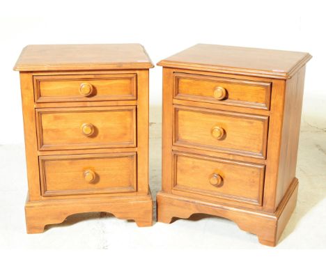 A pair of 20th century hardwood bedside chests of drawers / cabinets. Each having chamfered top over a bank of three drawers 
