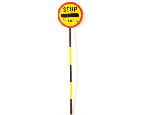 A vintage 20th century lollipop lady's hand held wooden sign. The sign circular with red border &amp; yellow ground, reading 