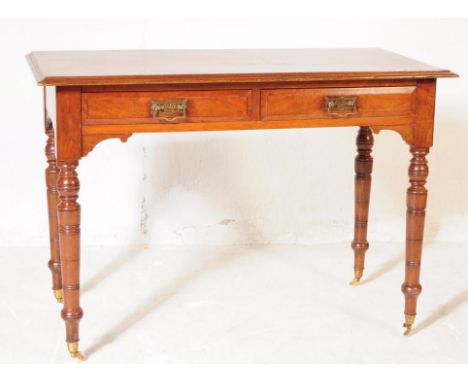 A 19th century Victorian mahogany writing desk / console hall table. The table raised on tapered turned supports terminating 