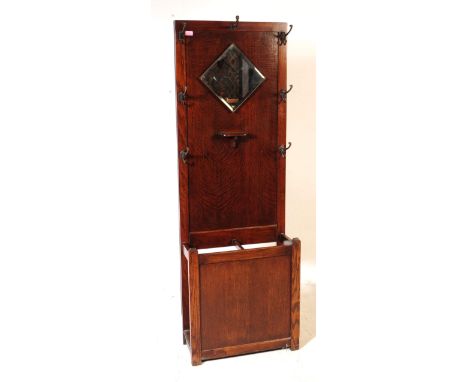 An early 20th century circa 1930s/1940s oak wood hall stand. The hall stand of rectangular form, with a canted square mirror 