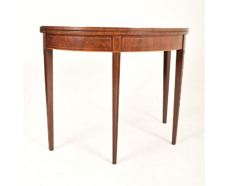 An 18th century George III inlaid mahogany games / card table. The table raised on tapering legs having half moon / demi - lu