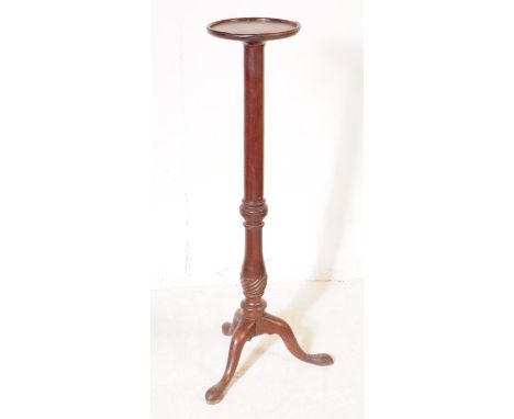 A 19th Century Victorian mahogany torchere / plant stand. Having circular table top upon rounded turned central column raised