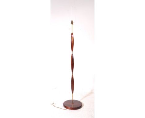A mid Century brass and wood Danish manner floor standing standard lamp having circular base. Lamp having circular wooden bas