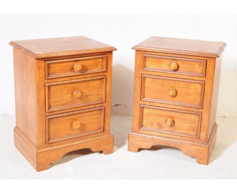 A pair of 20th century hardwood bedside cabinets. Each having chamfered top over a bank of three drawers with moulded edge an