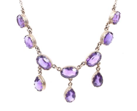 A modern 9ct gold and amethyst necklace in Victorian style. The front designed as a row of seven graduated oval mixed-cut ame