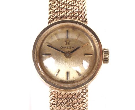 A vintage 9ct gold ladies Omega cocktail wristwatch. The gilt dial with batons denoting hours, on original 9ct gold mesh brac