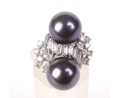 A South-sea black cultured pearl and diamond dress ring. In the form of a pair of 9.2mm diameter beads spaced by a baguette d