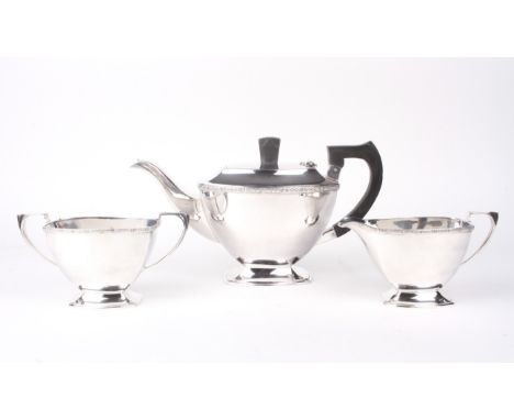 A silver three piece tea set. Cast with Celtic rope twist borders, comprising:a teapot and cover, a milk-jug and a footed two