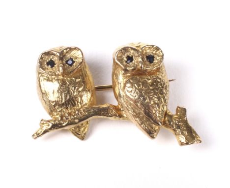 A vintage 9ct gold brooch in the form of two owls on a branch. Each with small very dark-blue/black sapphire eyes, hallmarks 