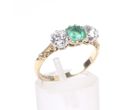 An early 20th century gold, emerald and diamond three stone ring. Centred with a cushion-shaped mixed-cut emerald approx. 0.4