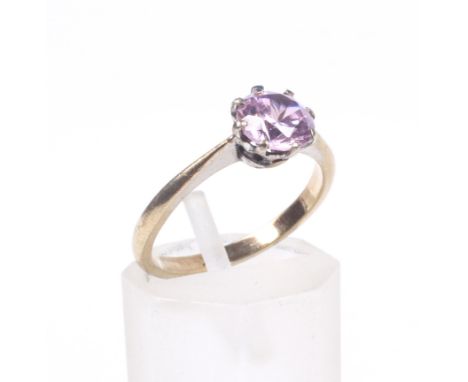A vintage yellow metal and pink cubic zirconia single stone ring. The round mixed-cut cz, in an eight-claw setting between kn