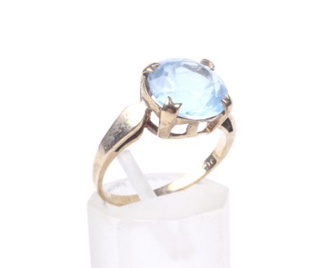 A vintage pale-blue paste single stone ring. The 10mm round mixed-cut paste claw set between spear-shaped shoulders, on a 'D'