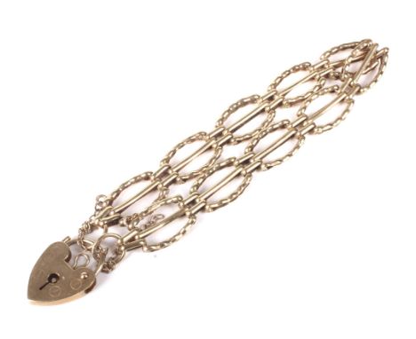 A vintage 9ct gold open bracelet. In the form of open oval links with shaped borders and central bars, on a padlock clasp wit