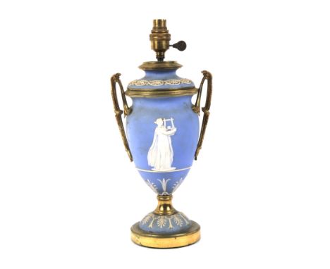 A Wedgwood light blue Jasperware and brass twin handled table lamp. In the form of a Greecian urn, the handles entwinded with