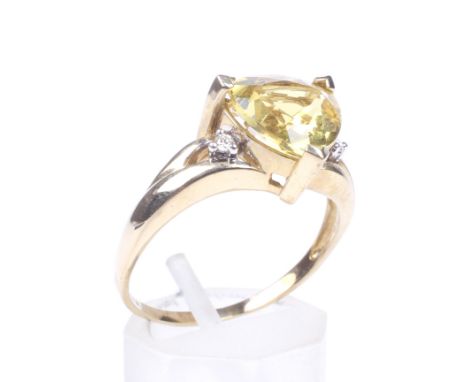 A QVC 9ct gold, yellow beryl and diamond dress ring. Centred with a trilliant-cut yellow beryl, approx. 2.75cts, claw set bet