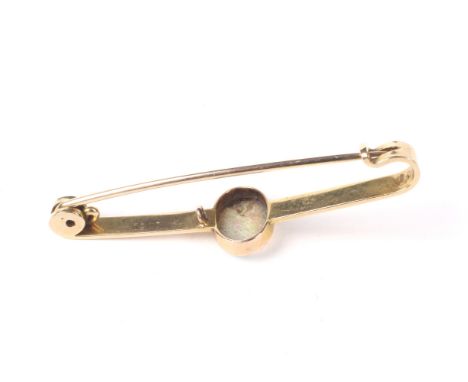 An early 20th century gold and opal single stone bar brooch. Centred with an oval cabochon white opal,  displaying a pleasing