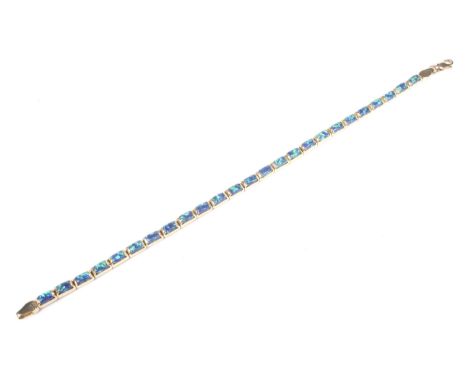 A Continental yellow metal and black opal bracelet. In the form of 25 oblong/cushion-shaped high-dome cabochon black opals, e