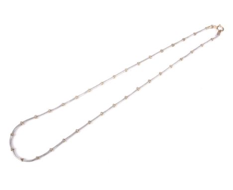 A vintage Italian 9ct bi-colour gold necklace. In the form of a white cable link chain with yellow beads at intervals, on a b