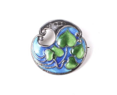 An Art Nouveau silver and enamel shaped-round brooch by Marples and Beasley. depicting trailing green leaves on a pale blue g