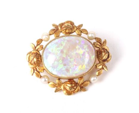 An early 20th century Continental gold, opal and seed-pearl brooch. The brooch of shaped-oval outline centred with an oval ca