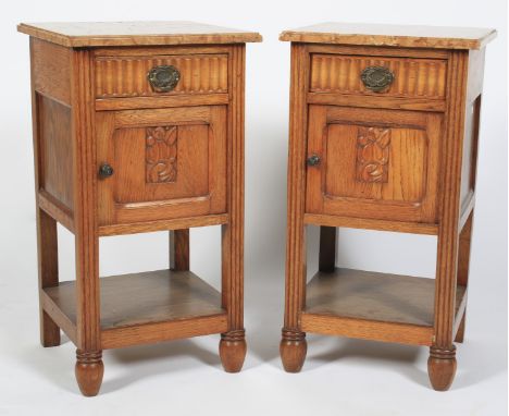 A pair of marble topped oak bedside cabinets. Each with drawers and carved cupboard door, with orange marble tops and lower s