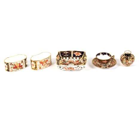 A group of Royal Crown Derby imari patten miniatures and two napkin rings. Printed iron-red factory marks, comprising: a teac