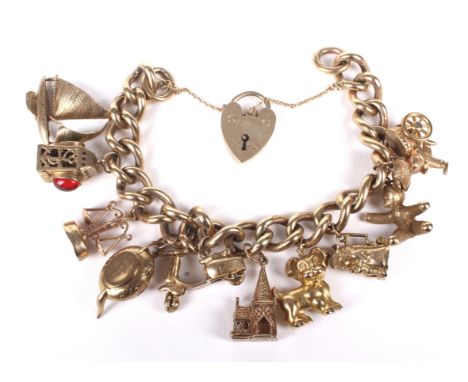 A vintage 9ct gold curb link 'Charm' bracelet on a padlock clasp. Hallmarks for Birmingham 1968 and hung with ten charms, com