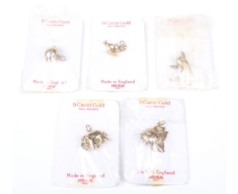 Five 9ct gold charms. All in original card and cellophane packaging, comprising; a rugby ball with hallmarks for Birmingham 1
