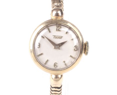 A mid century ladies 9ct gold Tissot cocktail watch. The circular dial with gilt baton hour markers, Arabic markers quarter h