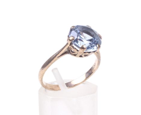 A vintage 9ct gold and bright-blue synthetic-spinel single stone ring. The round mixed-cut, mid-blue synthetic-spinel claw se