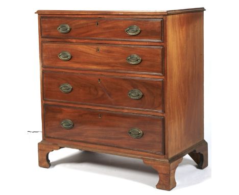 A Georgian mahogany chest of drawers. With four long graduating drawers with brass drop handles, raised on bracket supports L