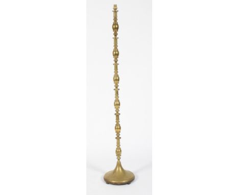 A Brass standard lamp. With turned bobbin style column raised on a circular base H162cm