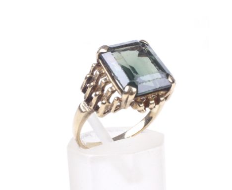 A vintage green synthetic spinel single stone ring. The cut-corner rectangular step-cut deep-green synthetic-spinel claw set 