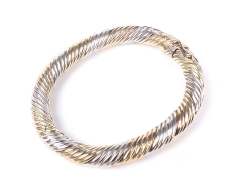 A vintage Italian 9ct bi-colour gold wire-twist bangle. Alternately bound with five-rows of white or yellow wirework, on a pu