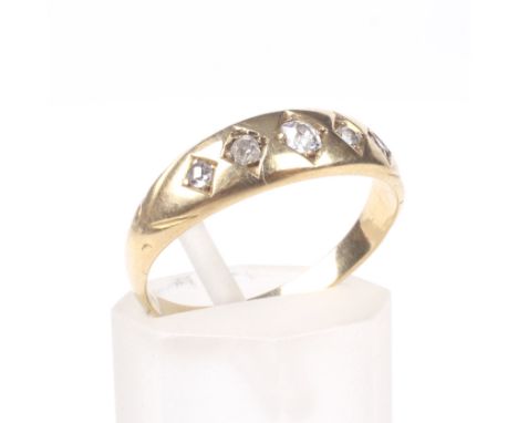 A late Victorian gold and diamond five stone gypsy ring. The graduated old-cut stones approx. 0.20cts total, each grain set w