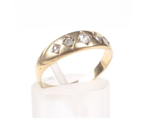 A late Victorian gold and diamond five stone gypsy ring. The graduated old-cut stones approx. 0.20cts total, each grain set w