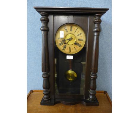 A wall clock with pendulum and key 