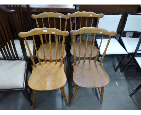 A set of four beech stick-back chairs 