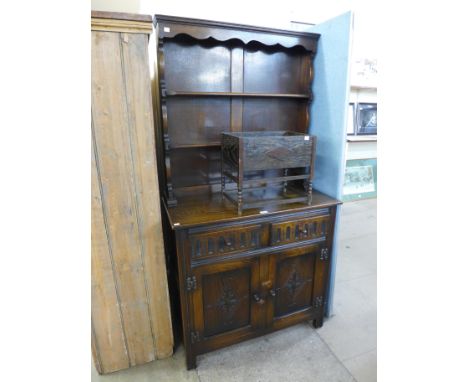 A carved oak dresser and an oak planter 