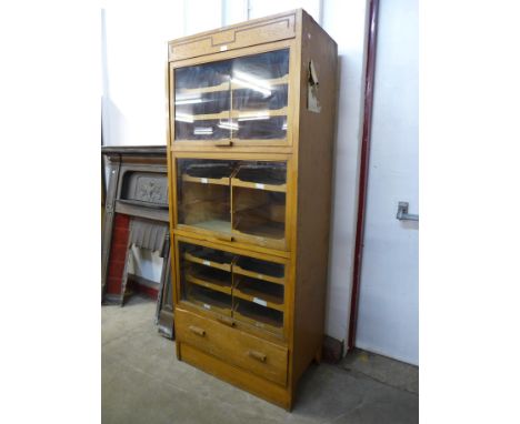 A mid 20th Century oak haberdashery shop cabinet 