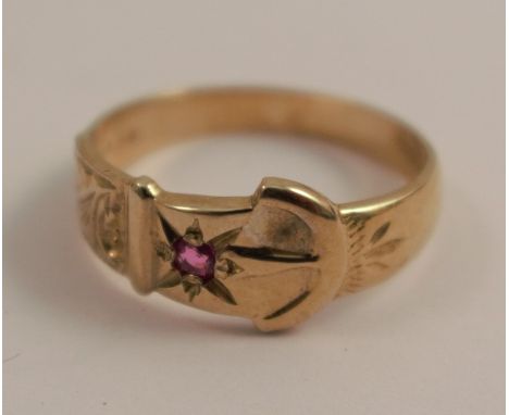 A 9 carat gold buckle ring, set with a ruby, finger size N, 2.6g gross