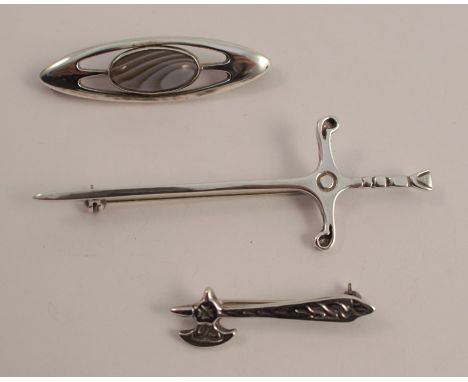 A Scottish silver agate brooch, Edinburgh 1979, possibly Malcolm Gray, together with a broad sword brooch, and an axe brooch,